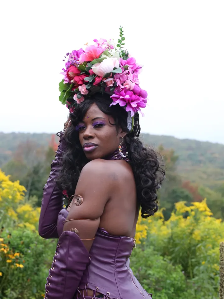 Dekya Royal in purple leather and a pink flower crown at Goddess Gathering 2026
